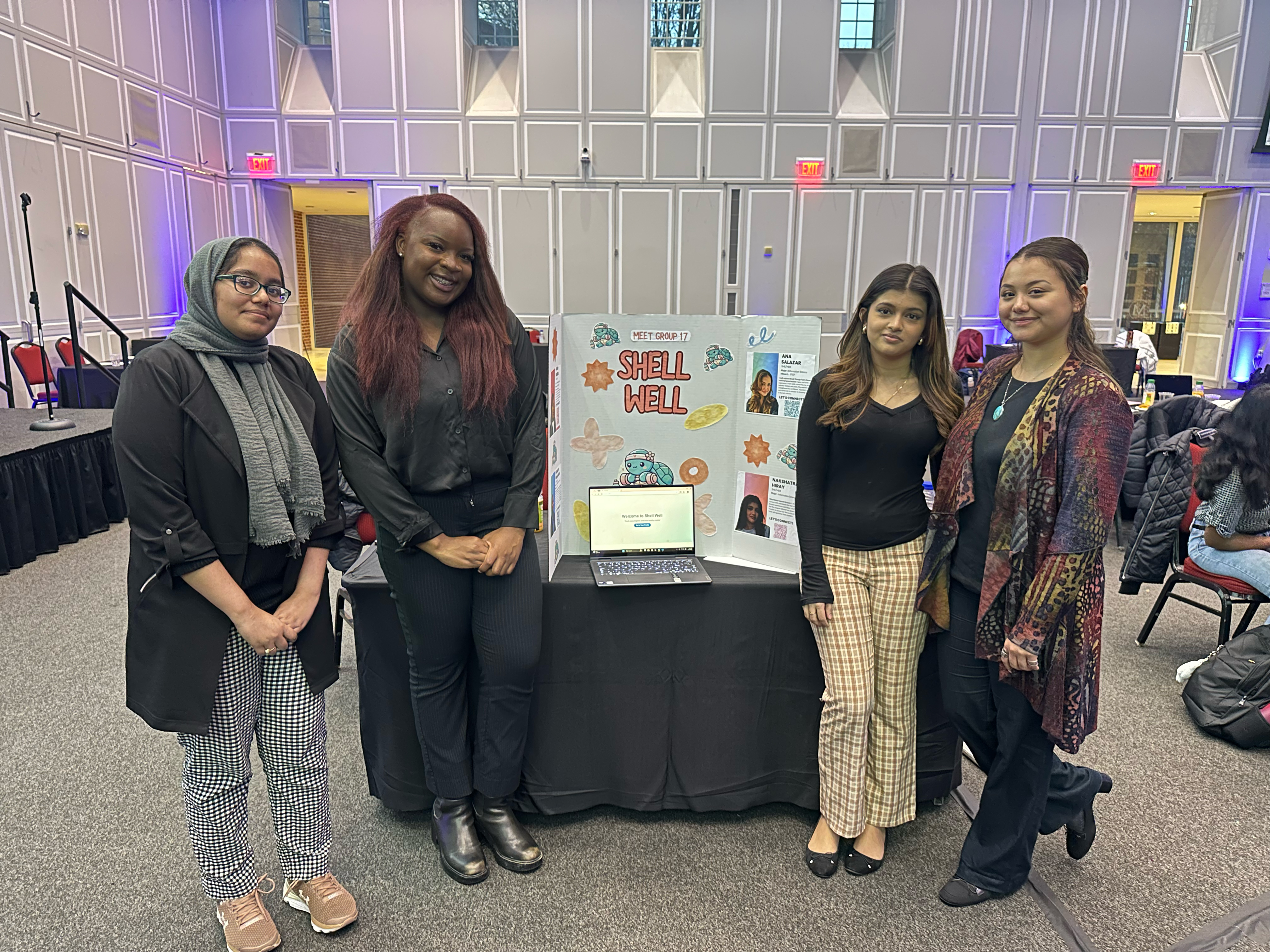 Group of four students standing with a trifold poster at Career Launch Expo
