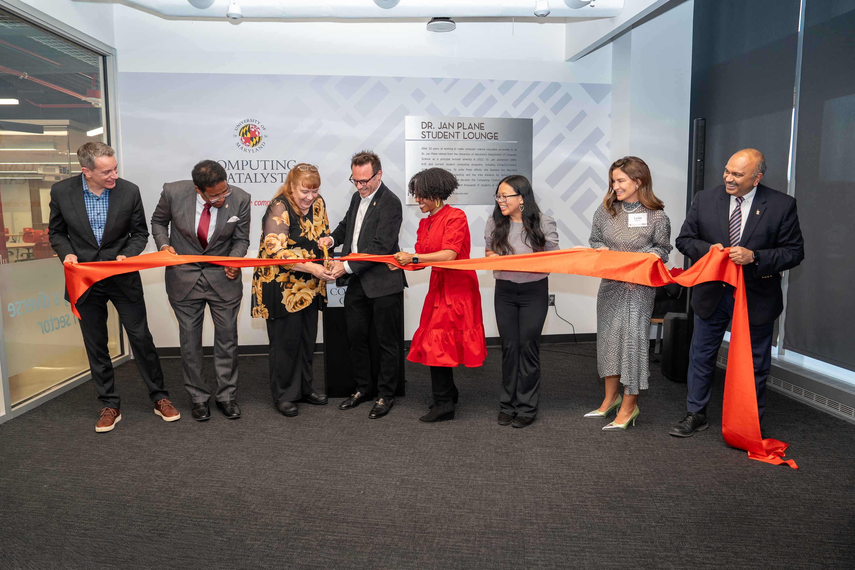Group of people cutting the ribbon to dedicate the Dr. Jan Plane Student Lounge