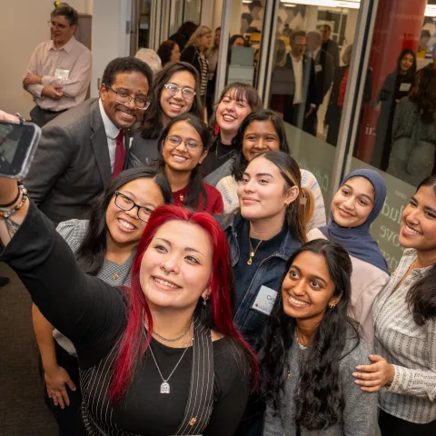 A group of individuals taking a selfie.