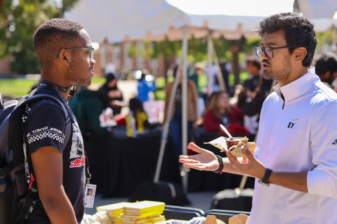 An EY representative talks with a student.