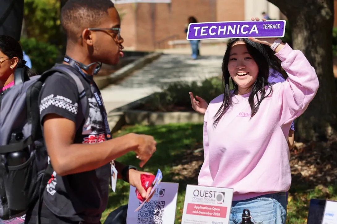 A Technica representative speaks with a student.