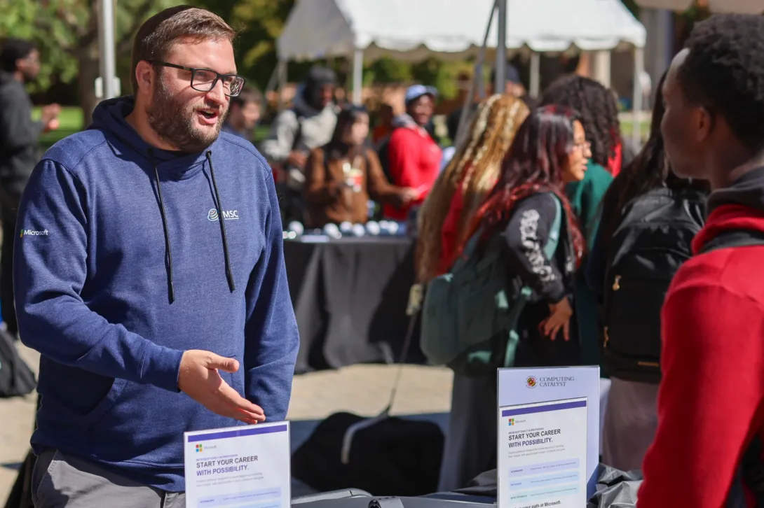 A Microsoft representative speaks with students.