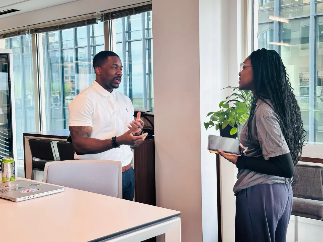 CapTech employee (left) speaking with RESET Scholar (right)