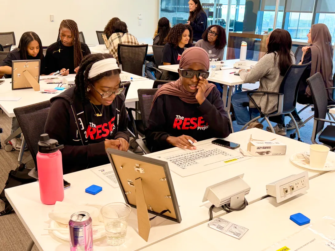Two RESET Scholars working together at a table