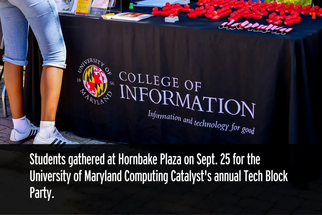 College of Information table with event materials and giveaways.